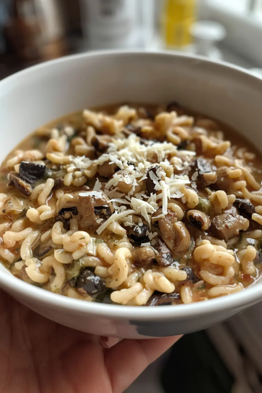 A photo of a creamy mushroom risotto in a bowl, topped with parmesan cheese