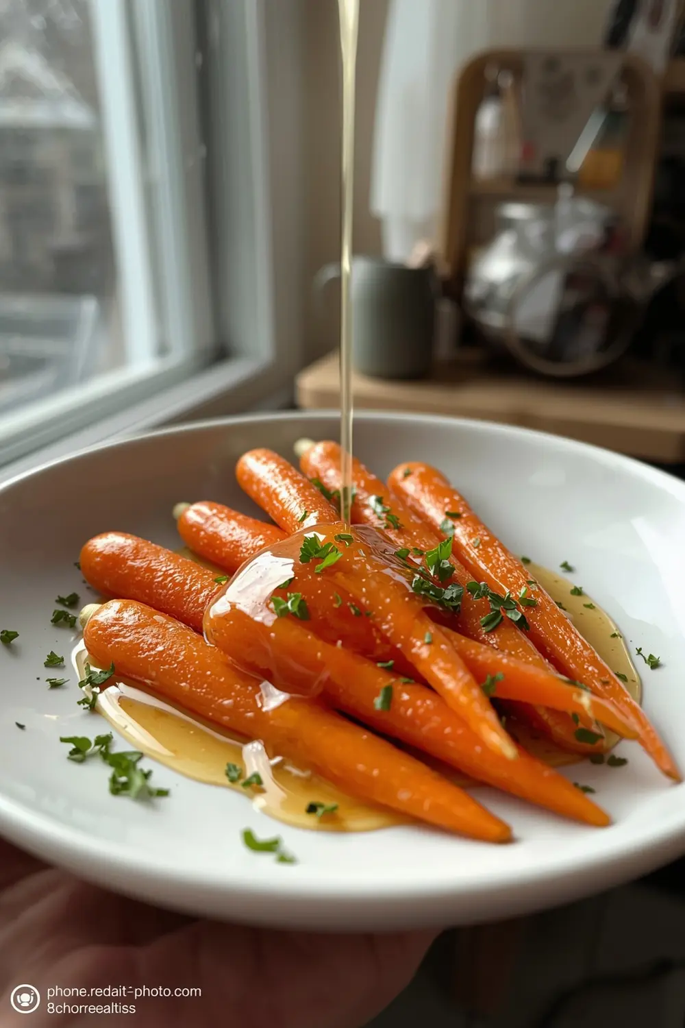 A photo of honey glazed carrots with parsley on a white plate